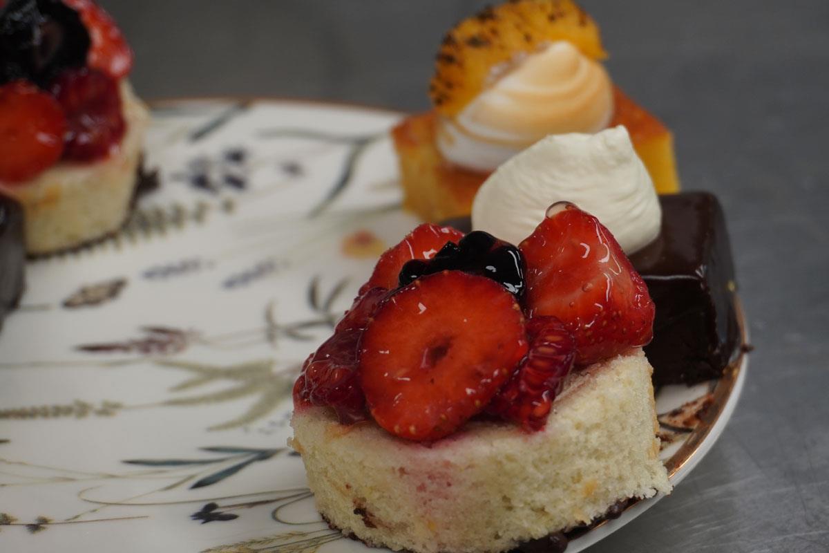 mini cakes with strawberries on plate