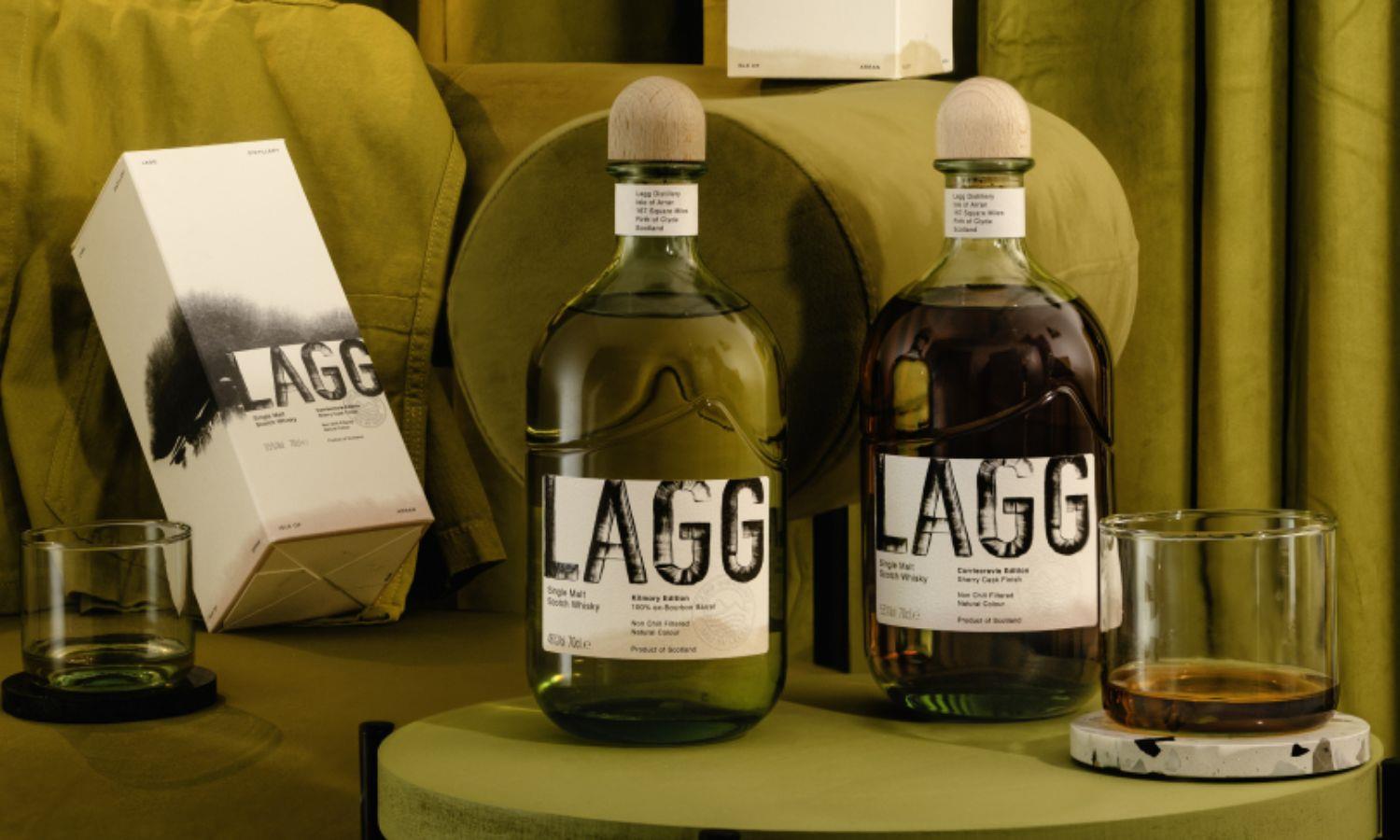 Two bottle of Lagg whisky on green seating with two drams of whisky poured