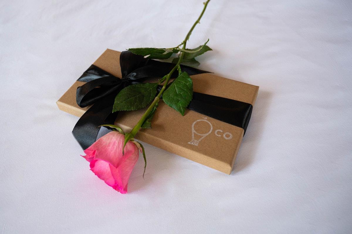 Rose on a bed with a gift box