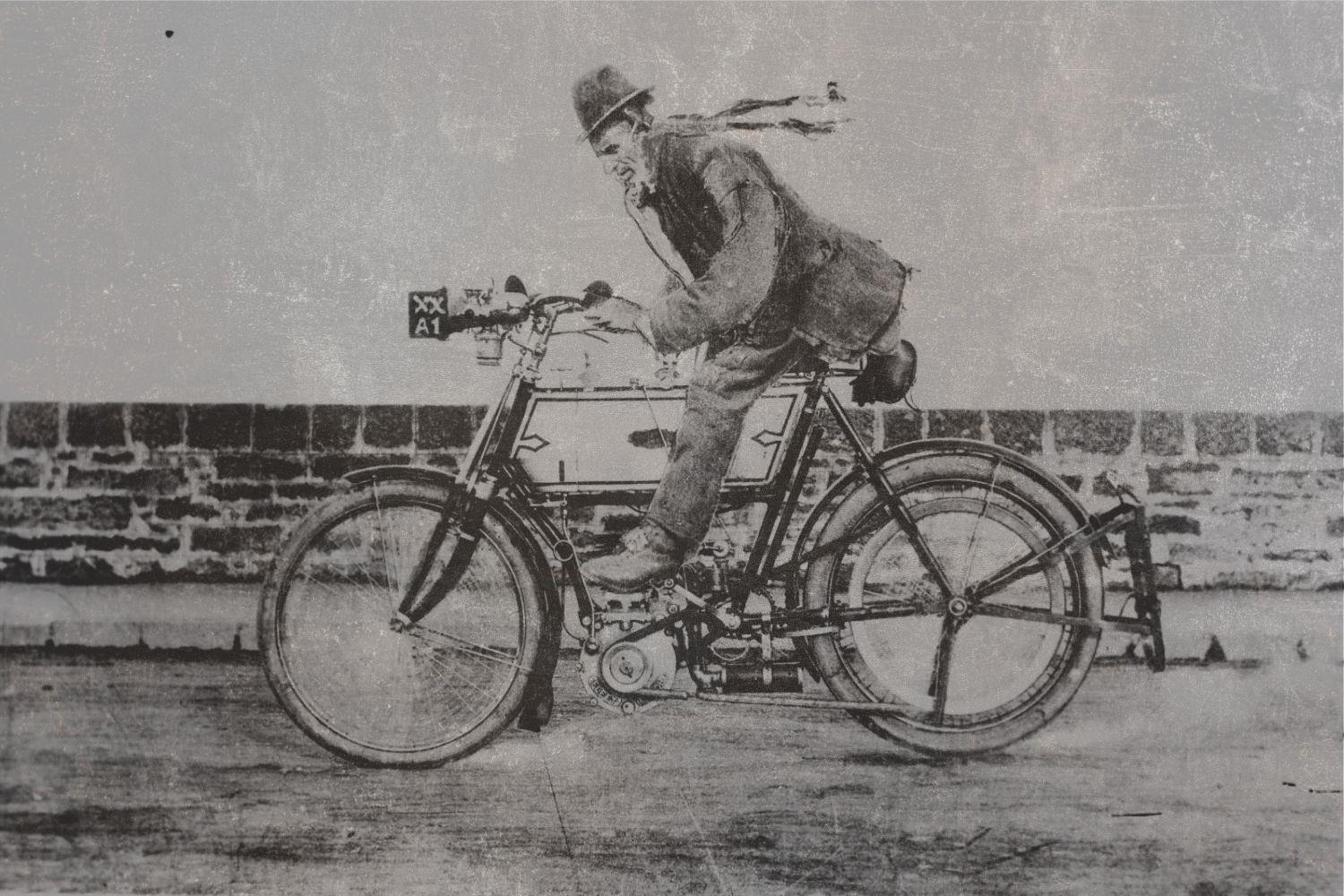 Black and white vintage image of man on a bicycle