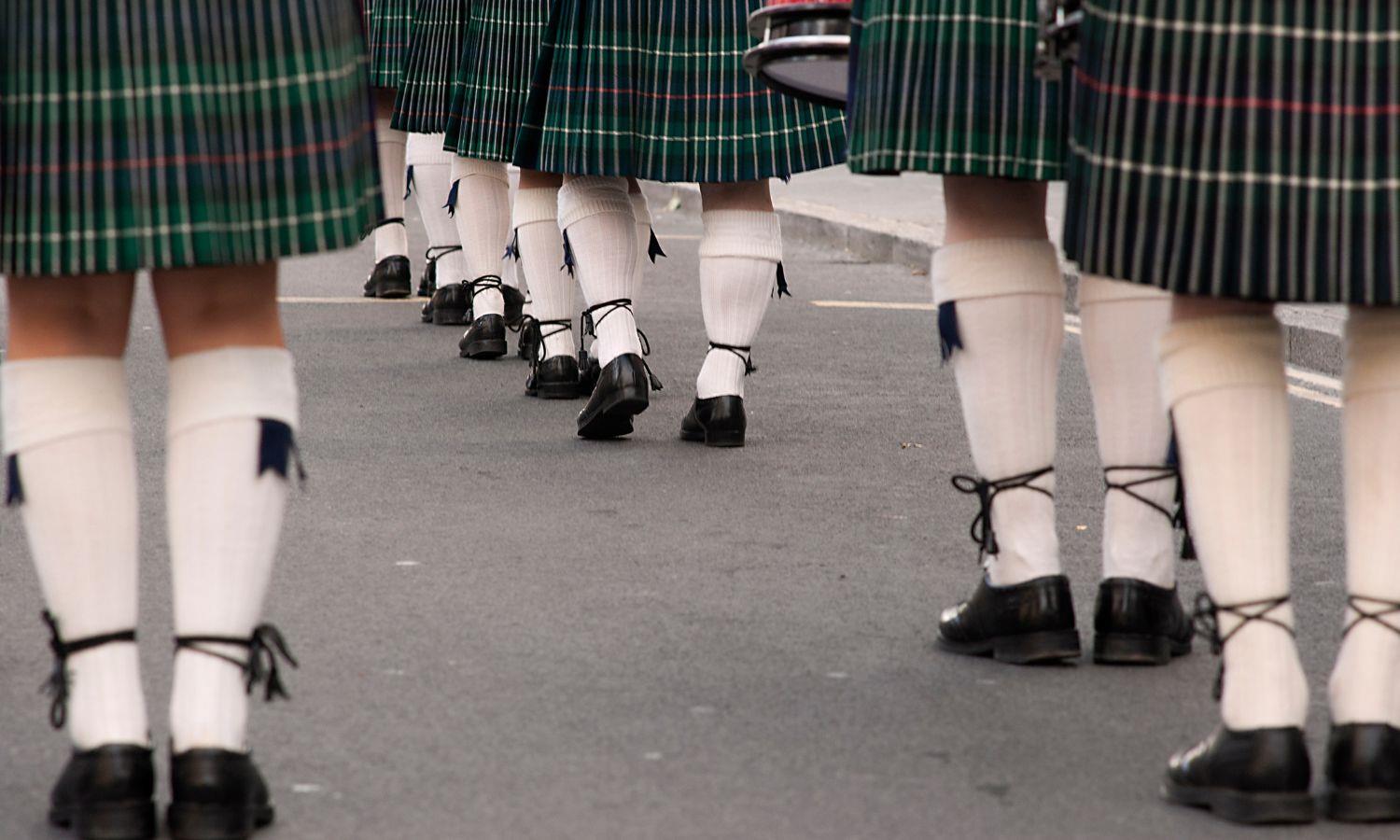 People lined up in kilts at a Scottish festival