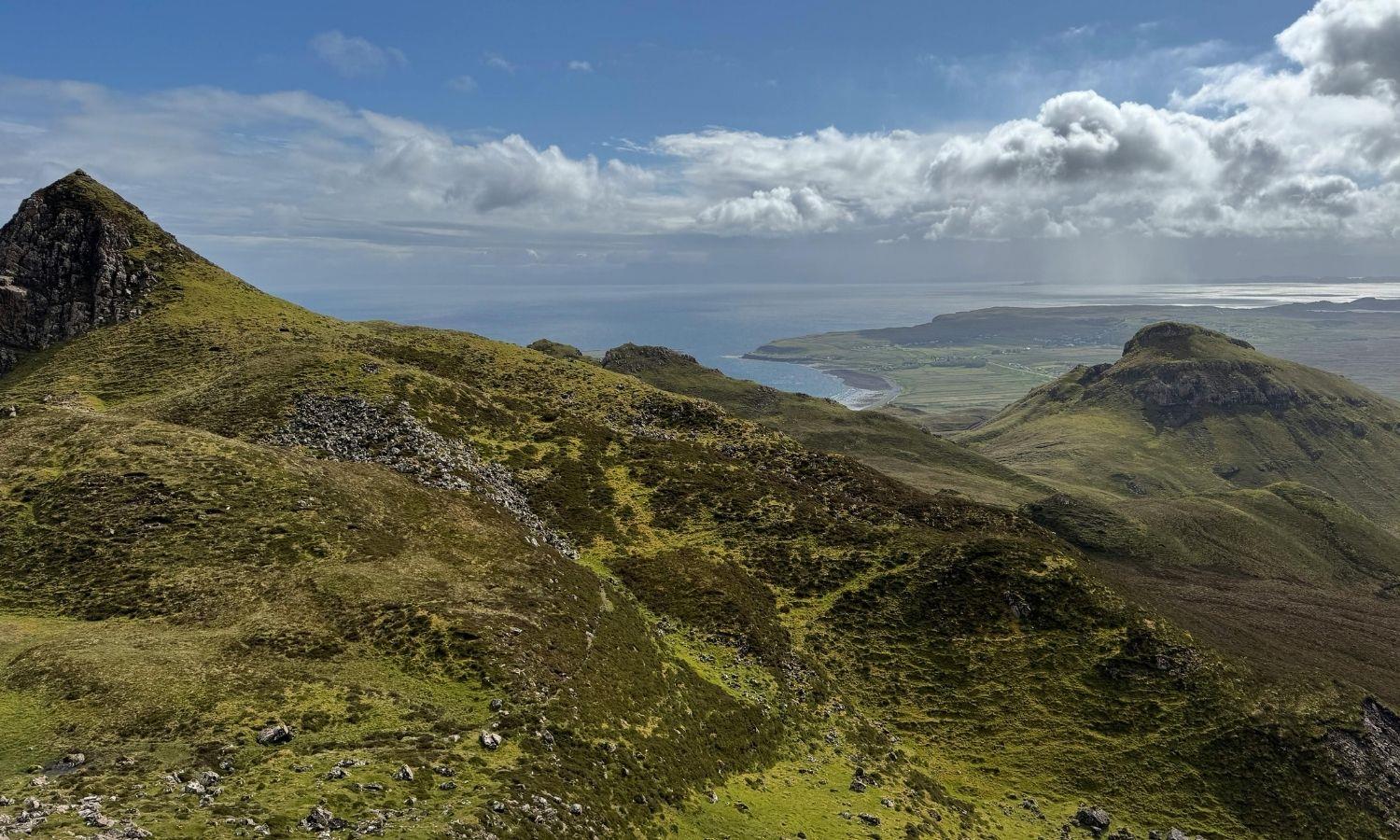 Panoramic view of the Quiraing on Isle of Skye, with rolling hills, dramatic cliffs and coastline