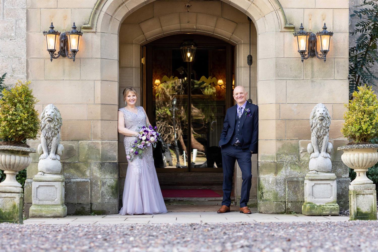 Bride and groom in the castle's entrance
