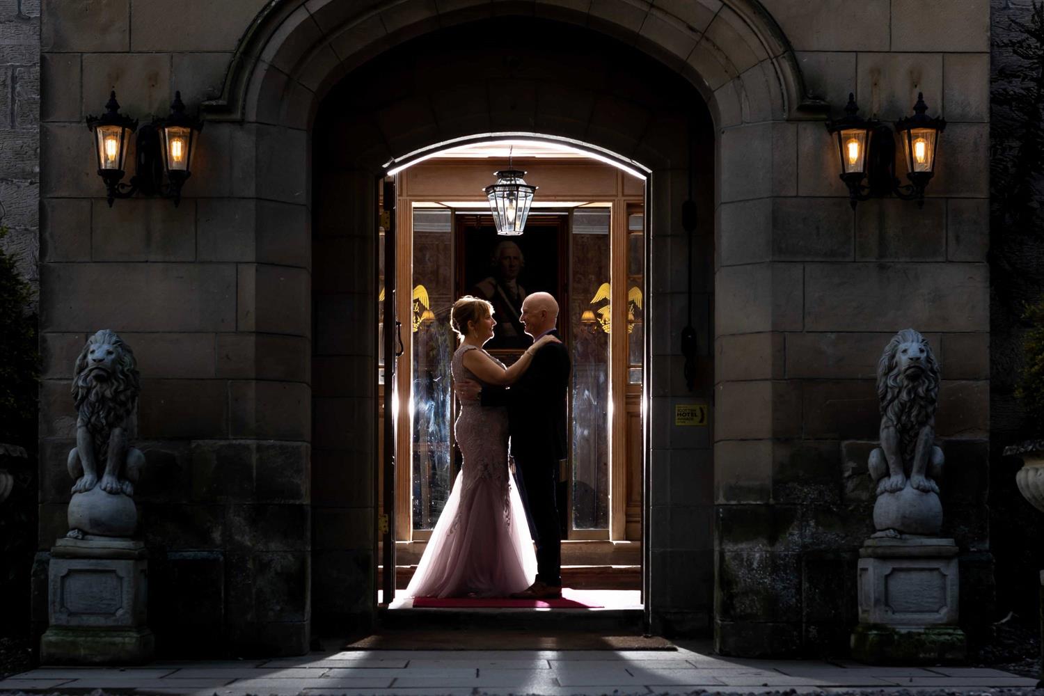 Bride and groom at the castle's entrance