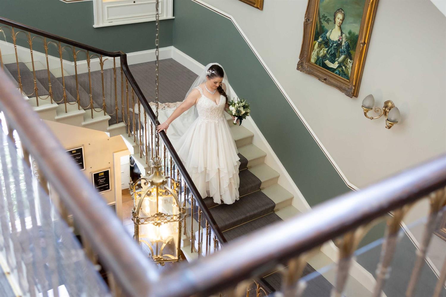 Bride walking down grand staircase