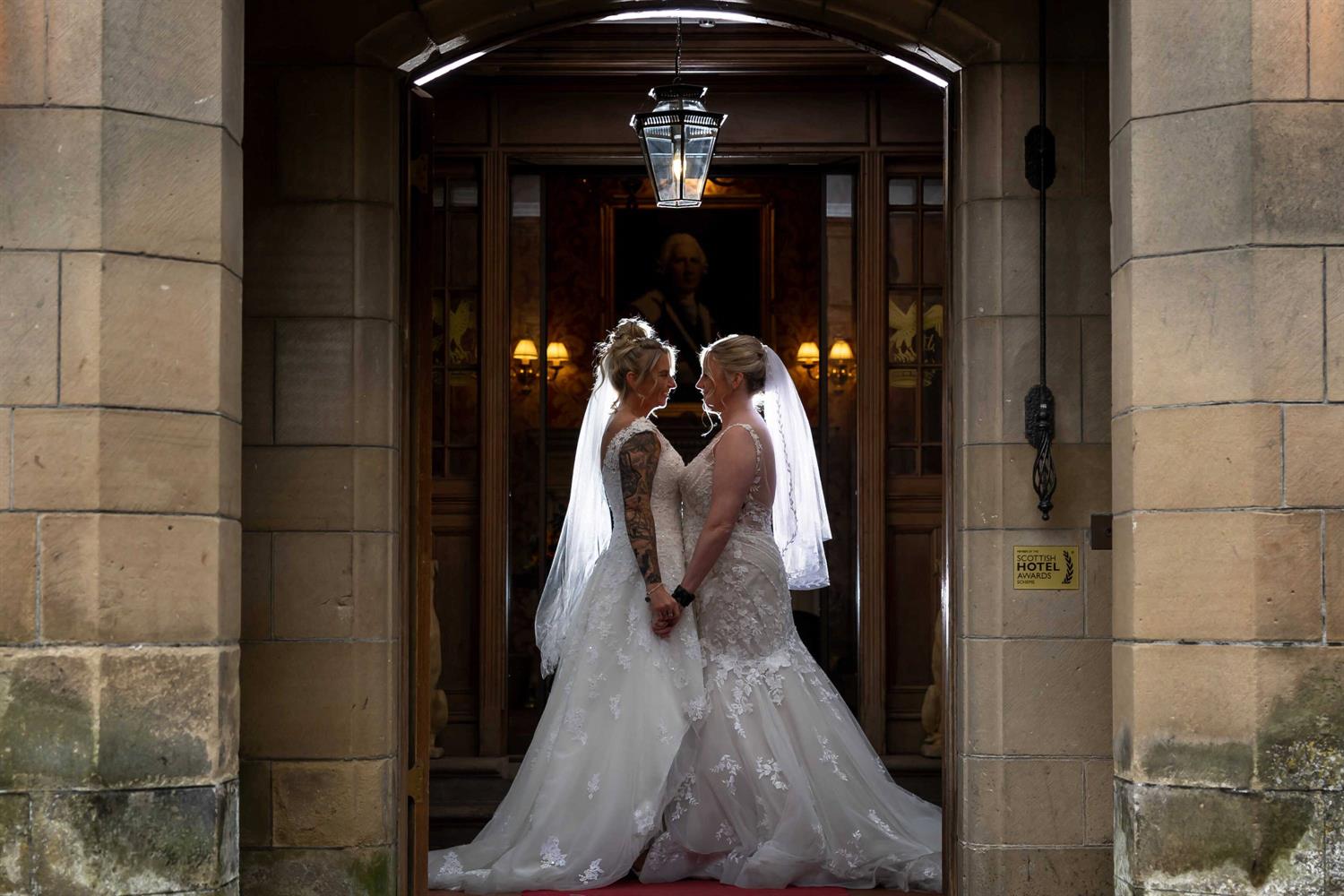 Two brides in the castle's entrance