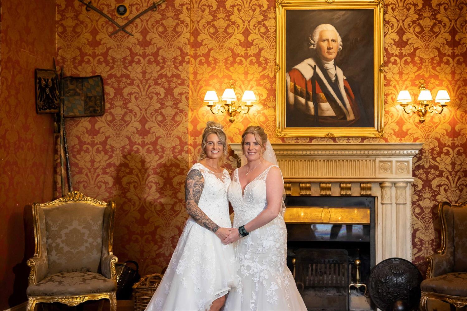 Two brides by a fireplace