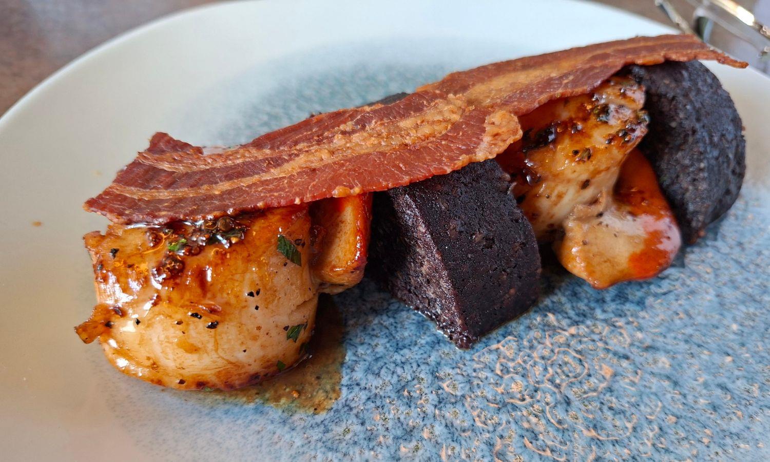 Scallops and black pudding with bacon served fine dining style
