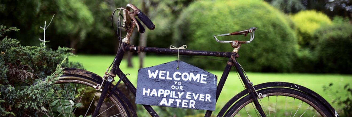 Vintage bike with sign reading 'welcome to our happily ever after'