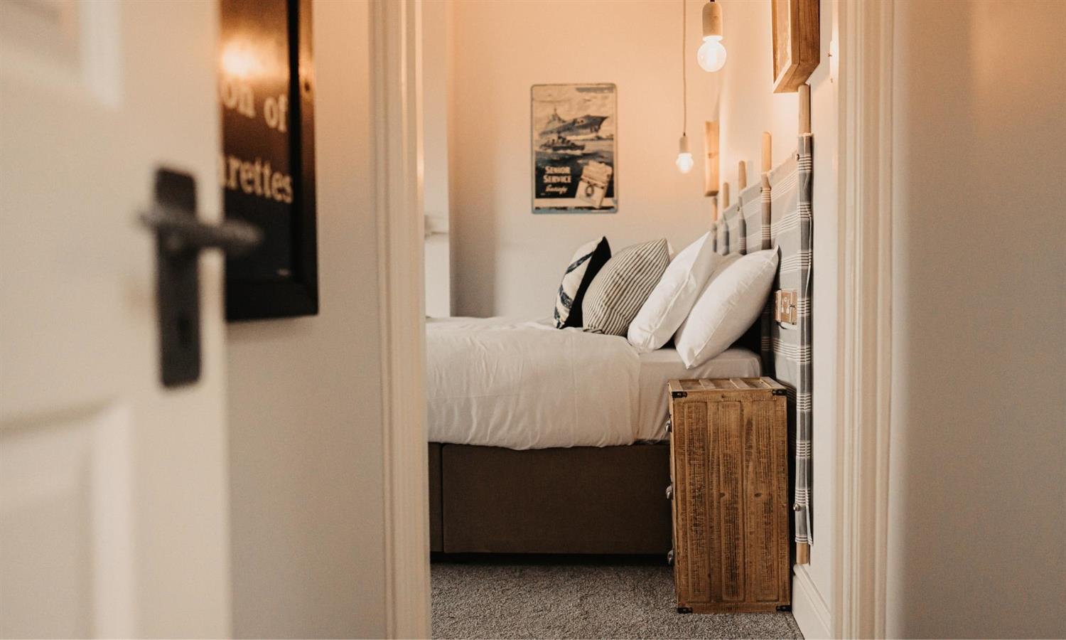 Hotel bed at The Ship Inn seen through doorway