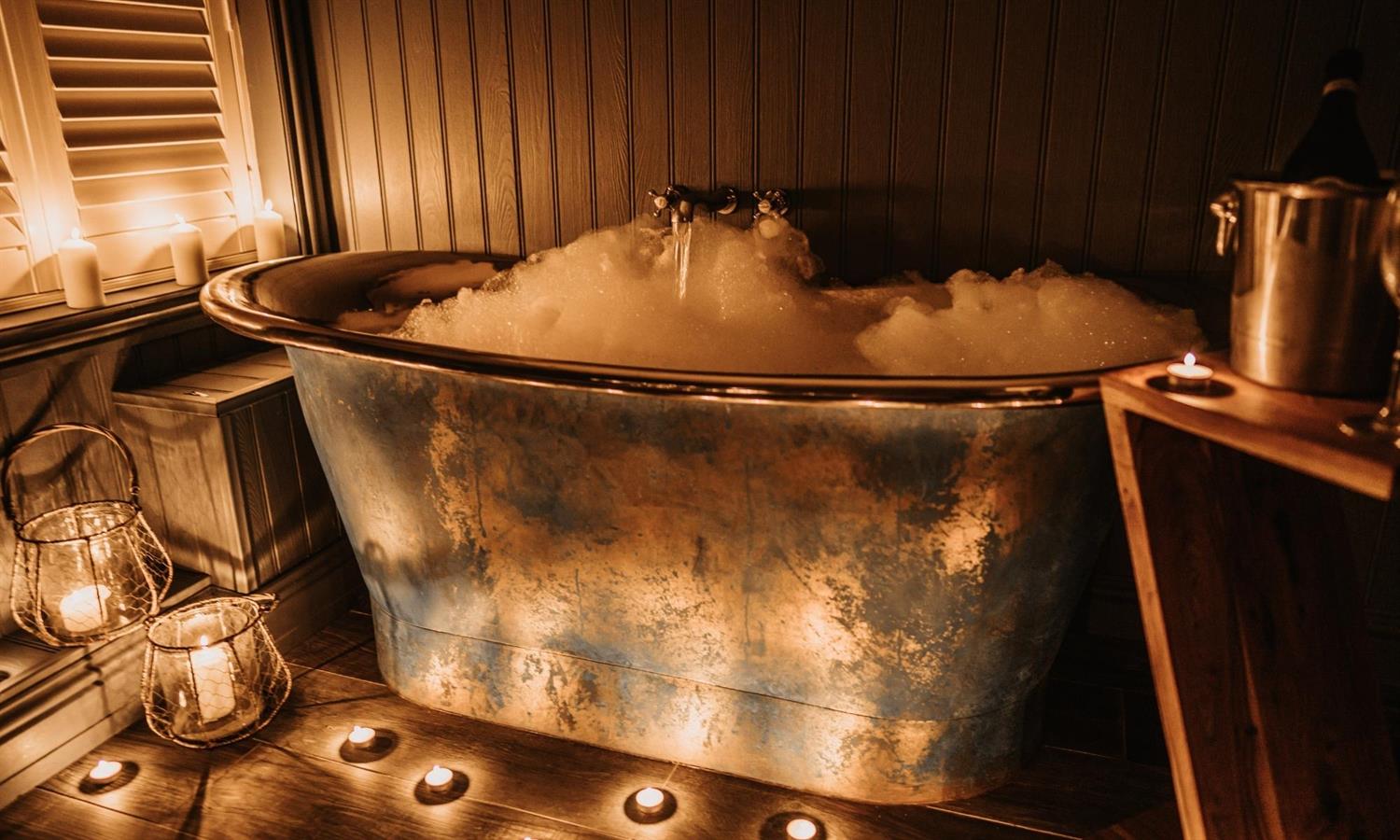 Bath with candles at The Ship Inn