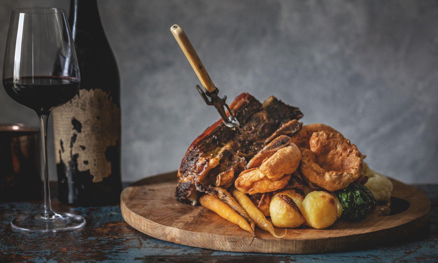 Sharing Sunday Roast with a glass of red wine 