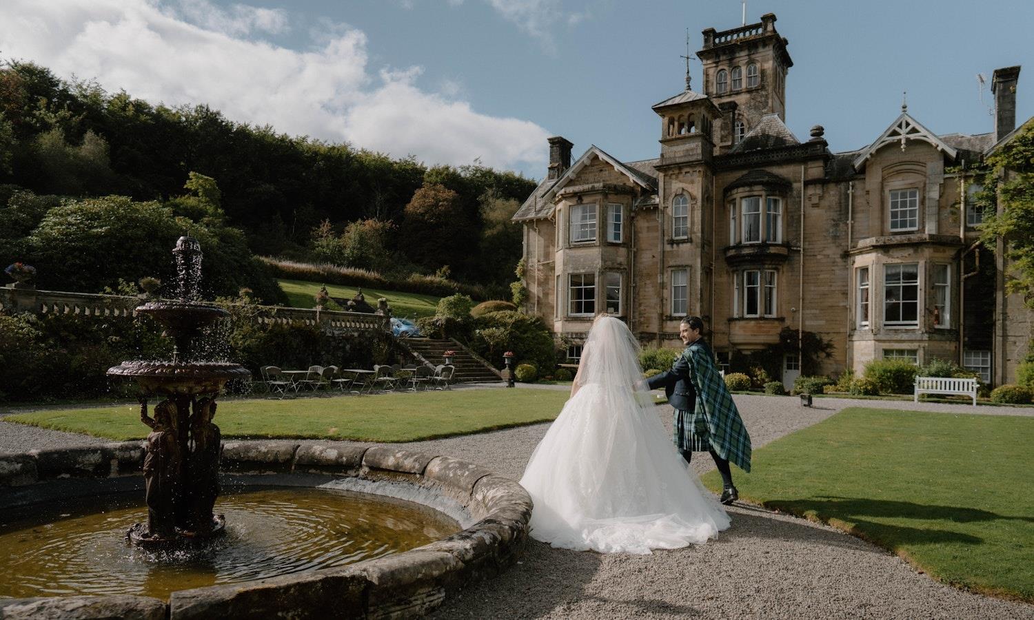 A happy couple outside the front of Auchen Castle