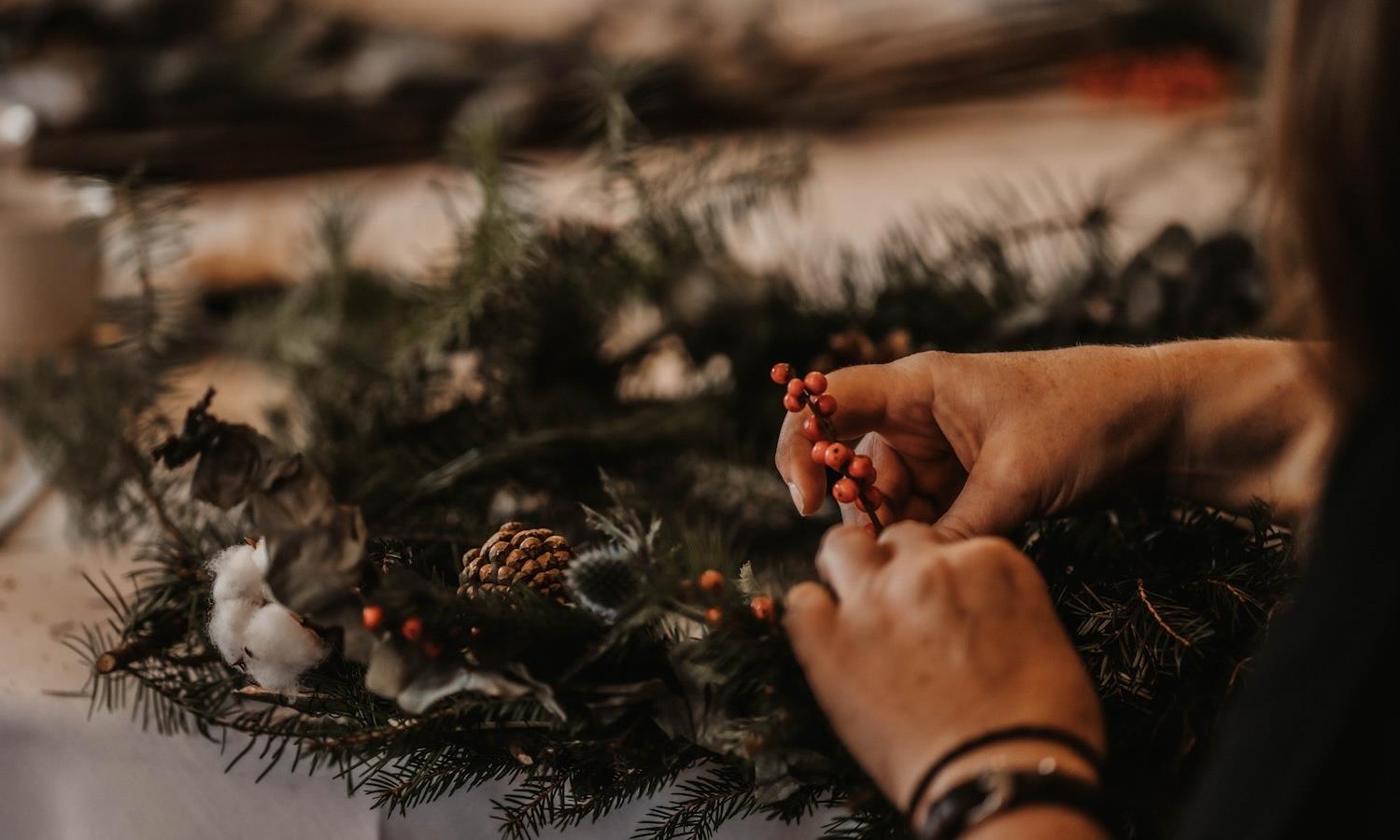 Close up of womans hands making a christmas wreath 