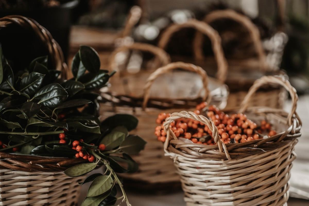Leaves & berries for Christmas wreaths in wicker baskets