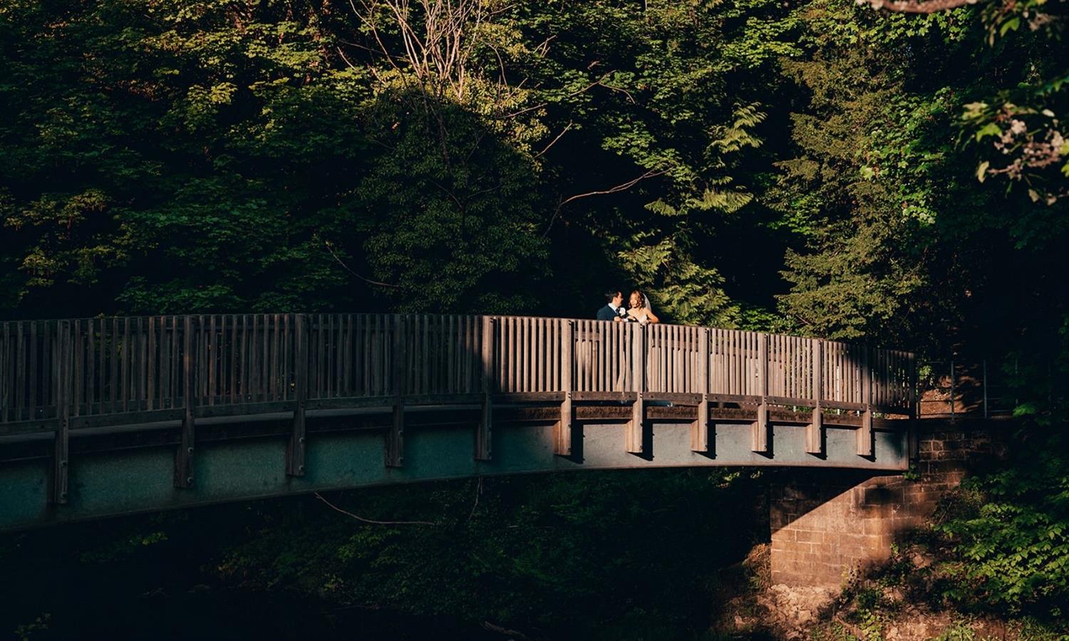 Wedding couple on a bridge in the grounds of Melville Castle