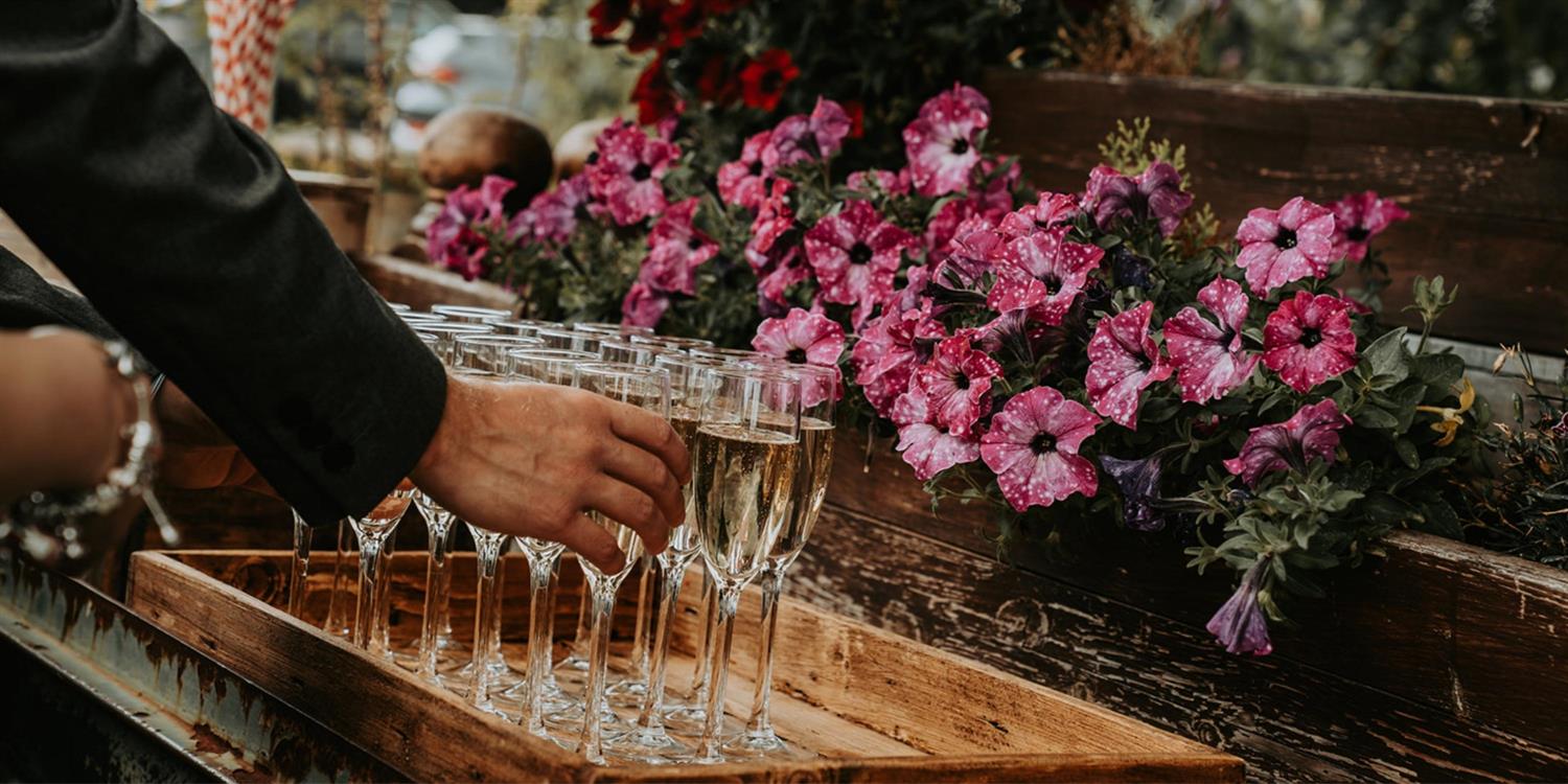 Hand reaching for a glass of champagne