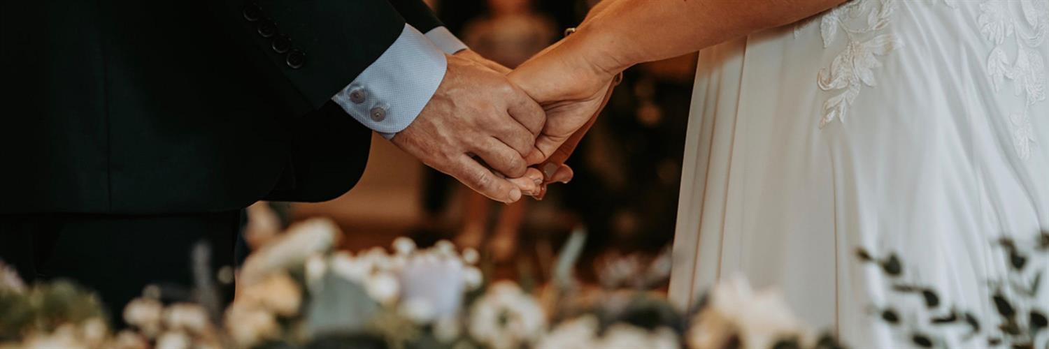 Hands of wedded couple