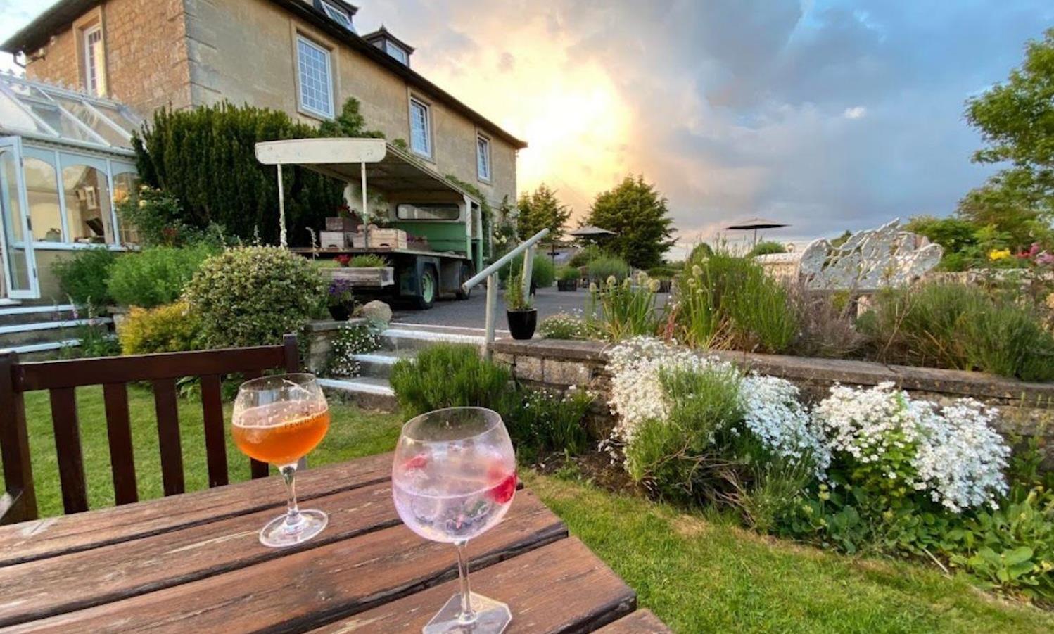 Gin glasses on table outside at sunset 