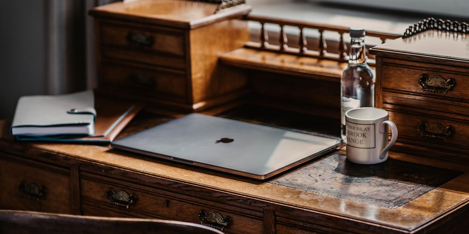 Laptop on an antique bureau