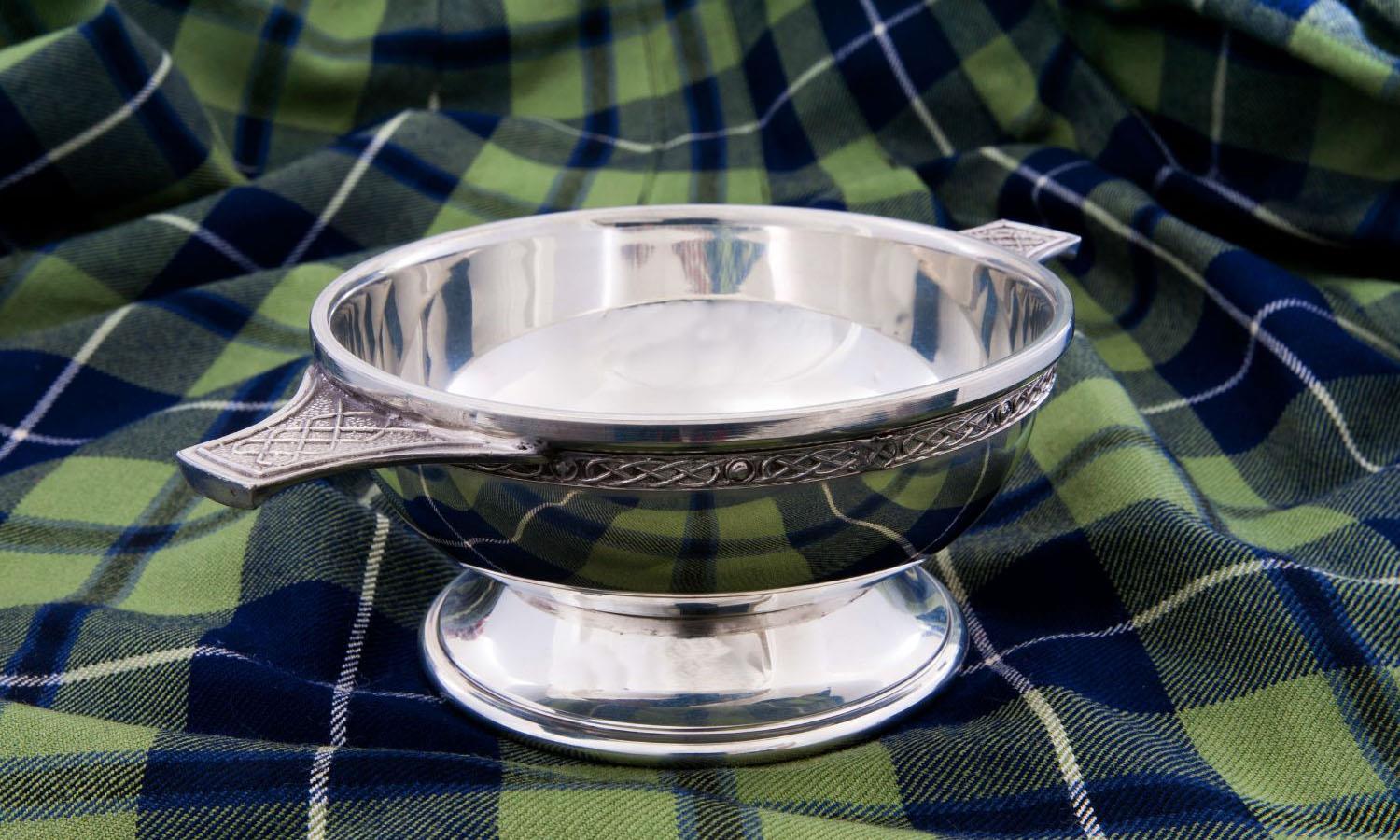 Quaich celtic wedding cup on tartan tablecloth