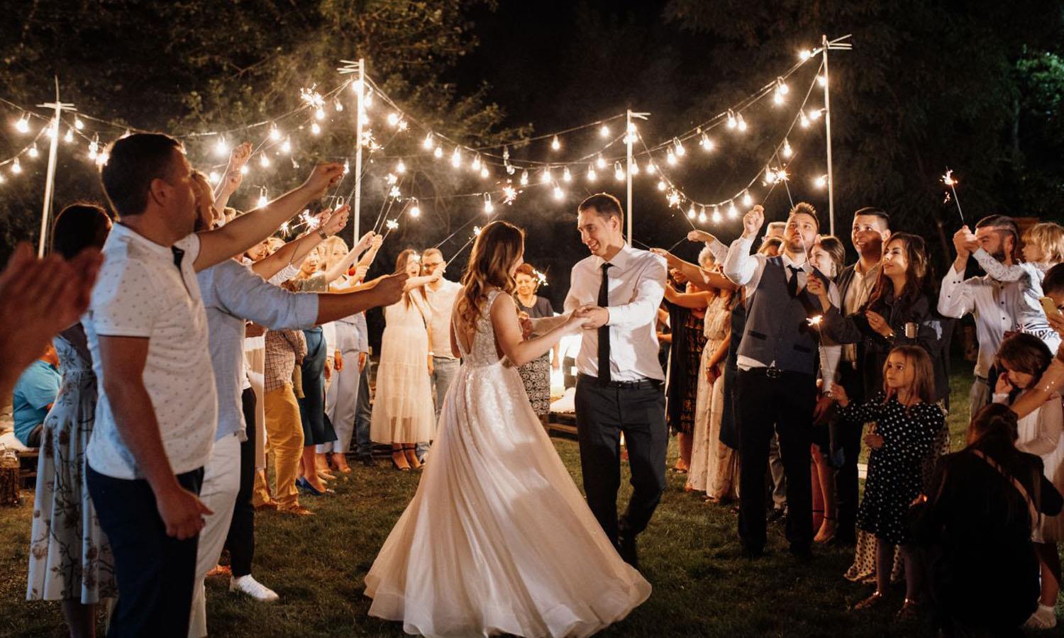 Couple dancing at a wedding surrounded by guests