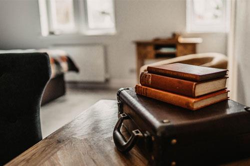 Books on a table in a bedroom at Broadford Hotel 