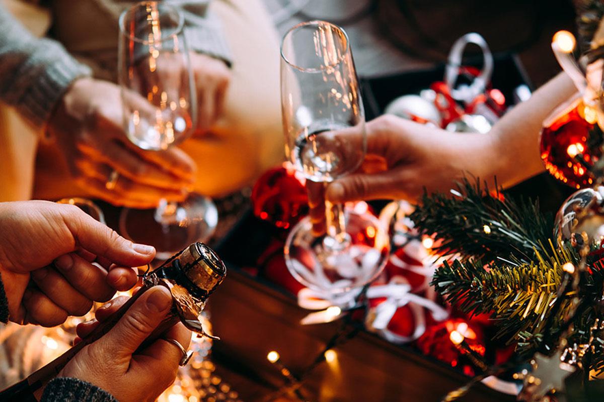 Glasses being clinked together at a Christmas party