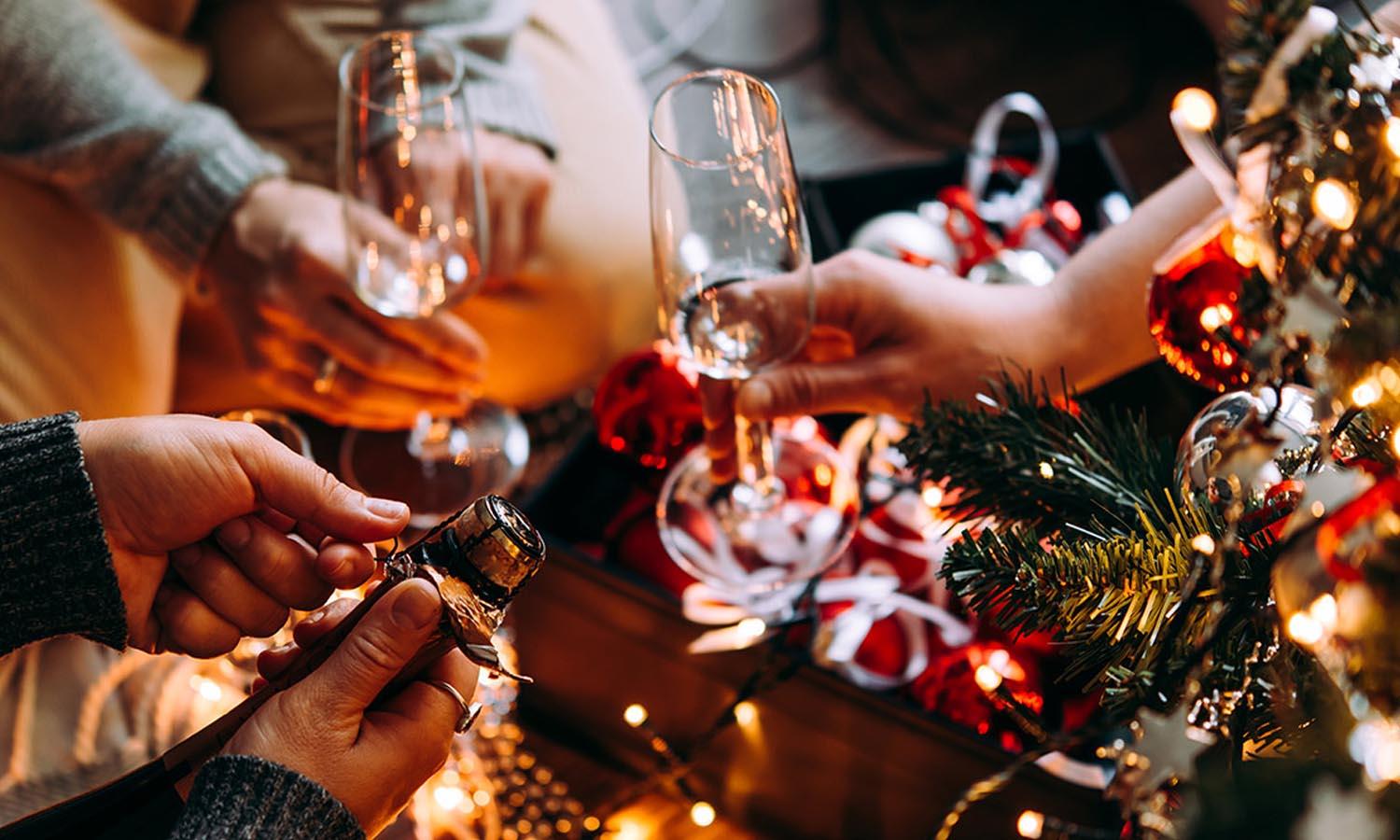 Bottle of Champagne and glasses ready to fill in front of a Christmas tree