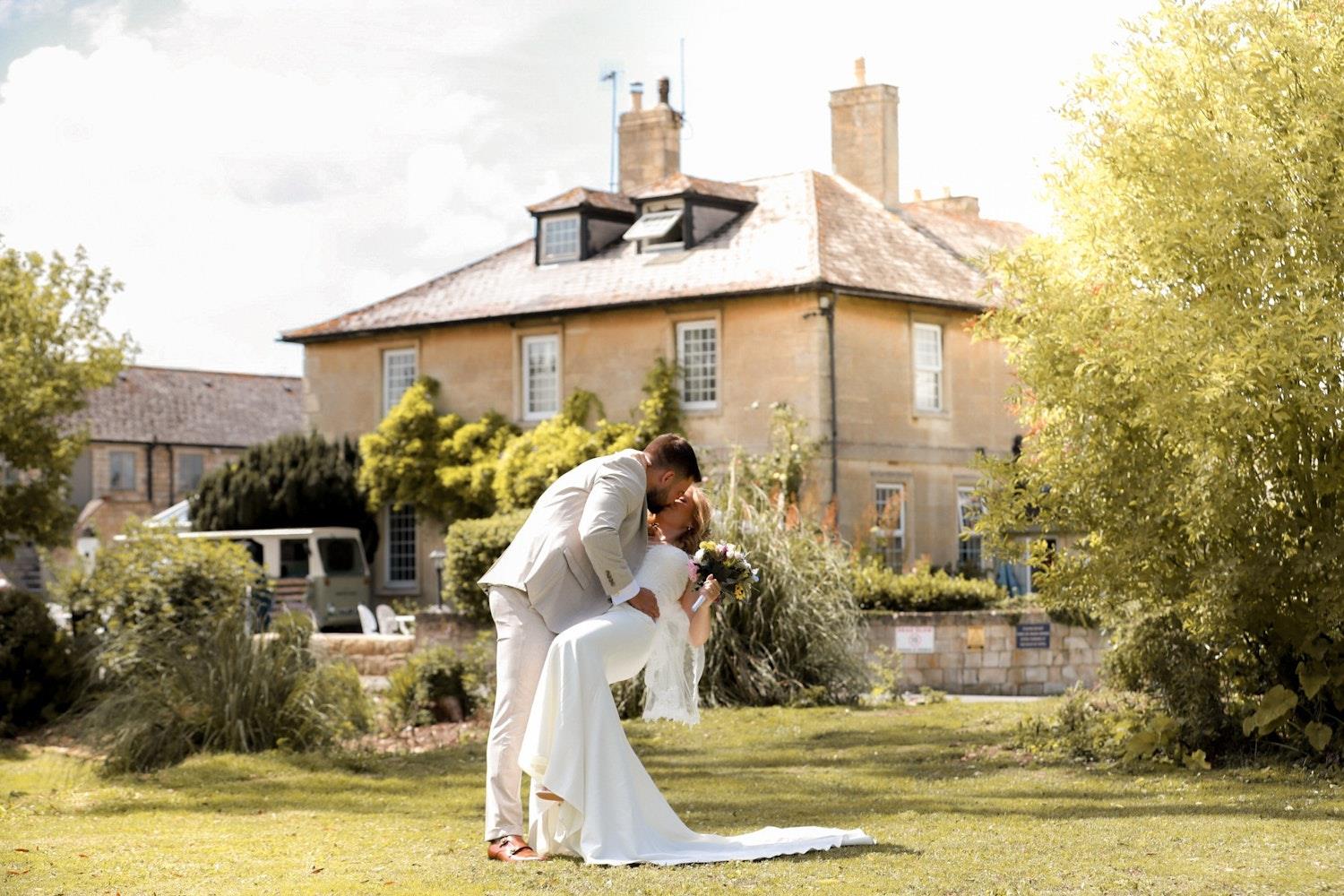 Bride and groom kiss in the gardens outside Widbrook Grange (c) Fresh Air Photography