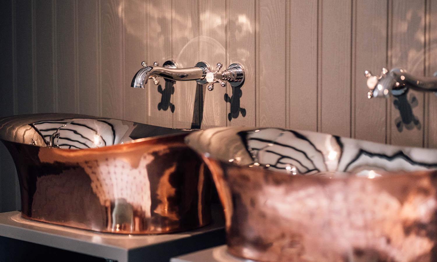 Twin copper washbasins in the ground floor bathroom at Miller's Cottage