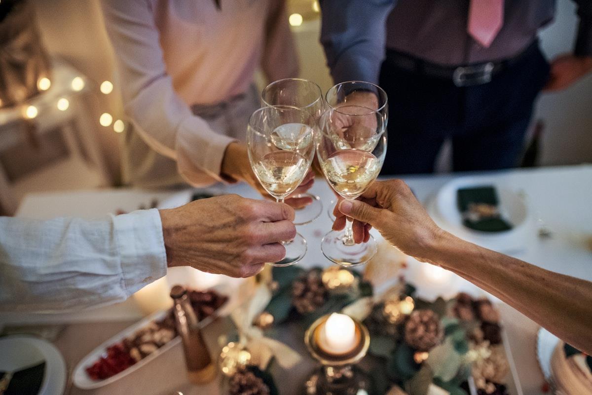 Four people toasting over a festive dinner