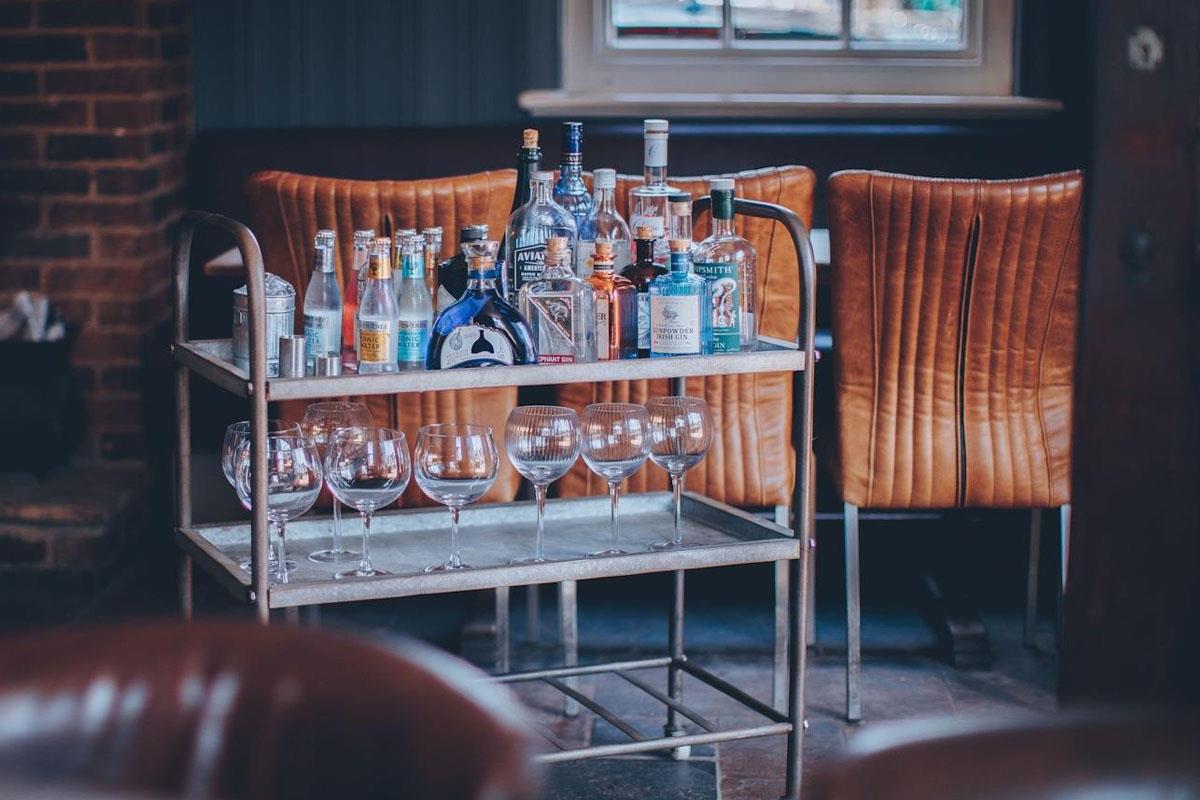 Bottles of gin & tonic on a bar cart