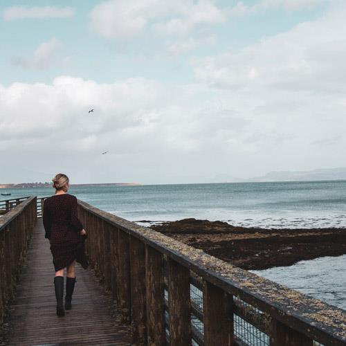 Woman looking out to sea on Skye