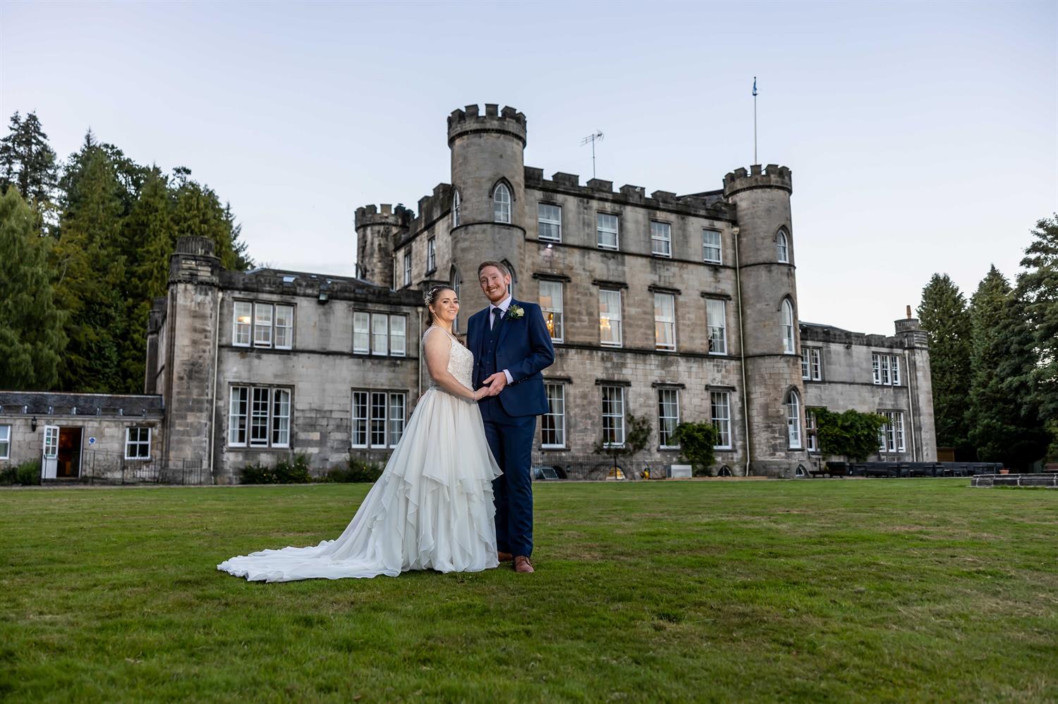 Bride and groom in front of a castle