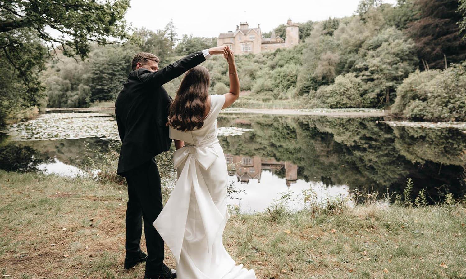 Couple dancing by lake at Auchen Castle