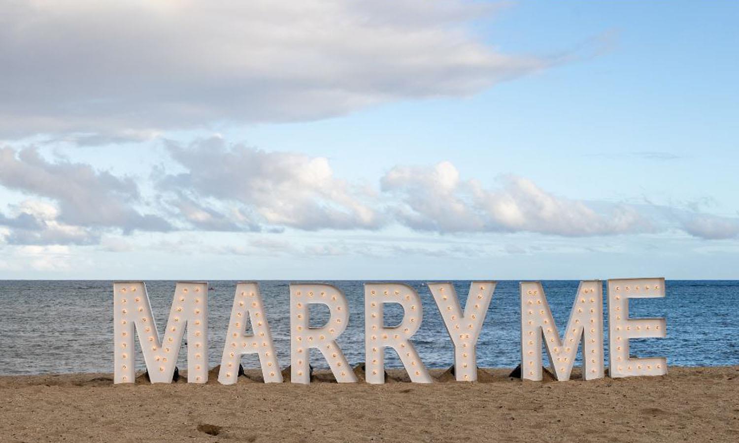 Marry me in lights on a beach