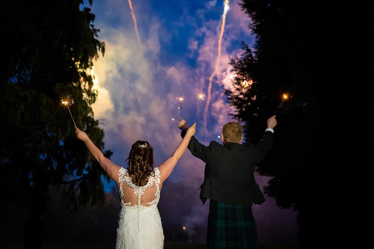 Wedded couple watches fireworks light up the night sky