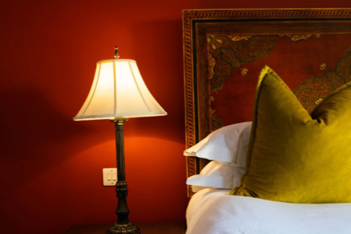 Lamp next to bed in boutique bedroom