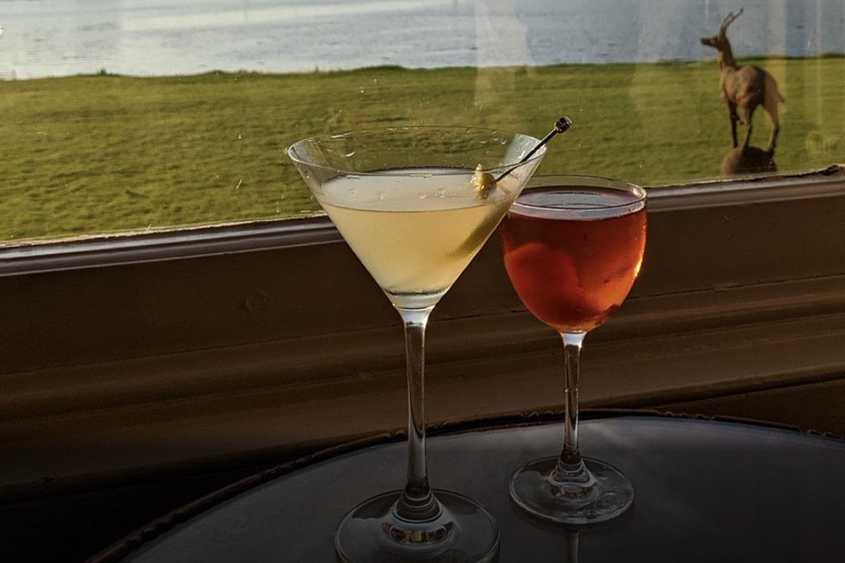 Two cocktails in window overlooking Shieldaig loch