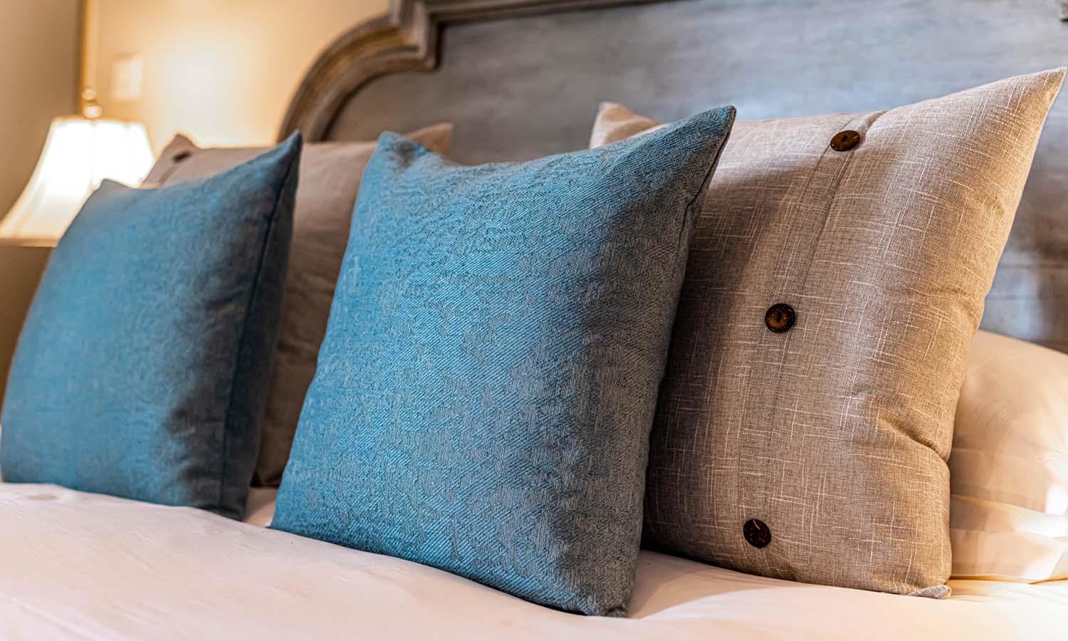 Blue & yellow cushions on a bed