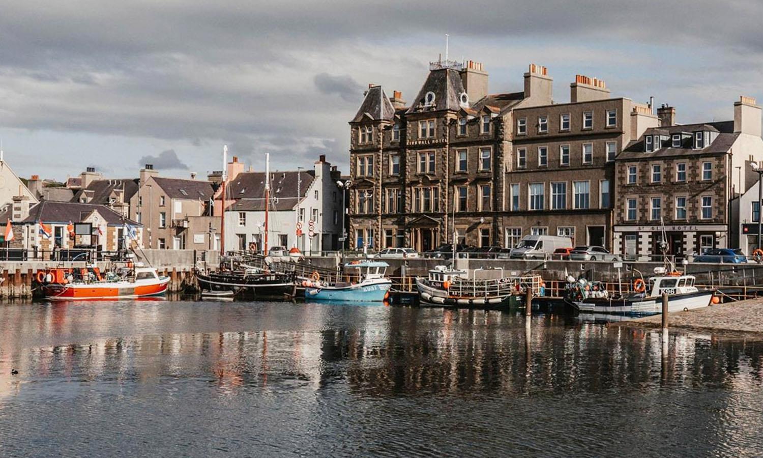 Front of Kirkwall Hotel in Orkney with boats on harbourside