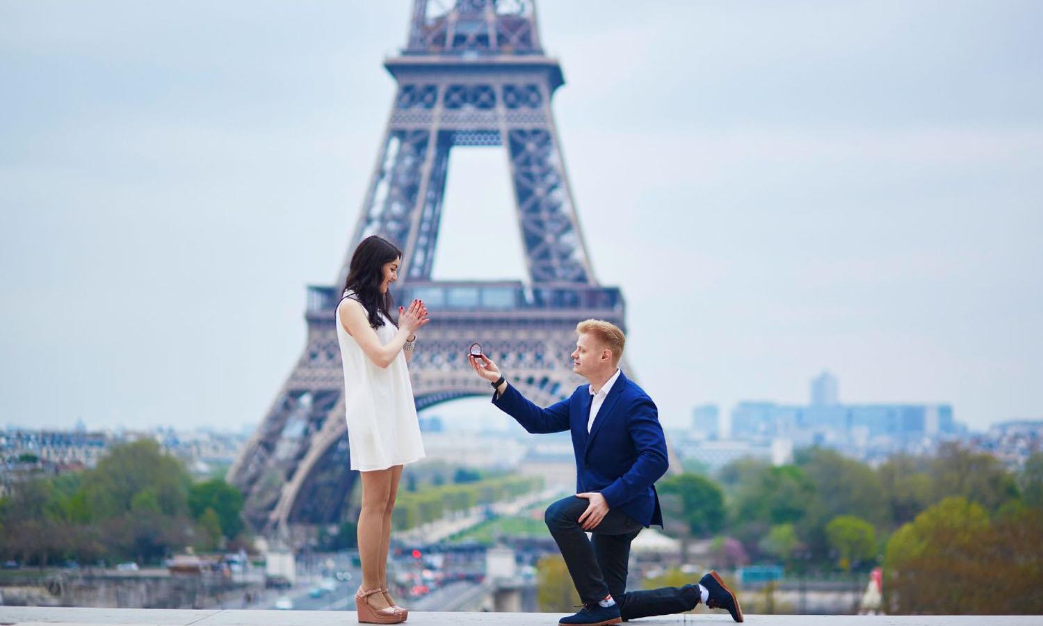 Man proposing to woman in front of the Eiffel Tower
