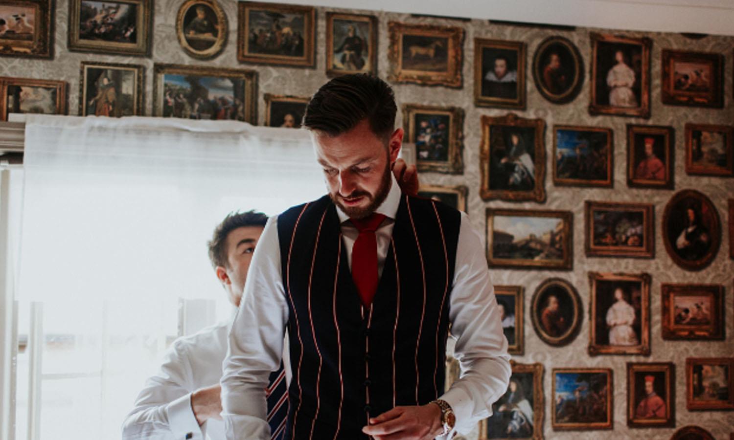 Groom dressing ready for the wedding ceremony. Photo Credit: Oxana Mazur Photography