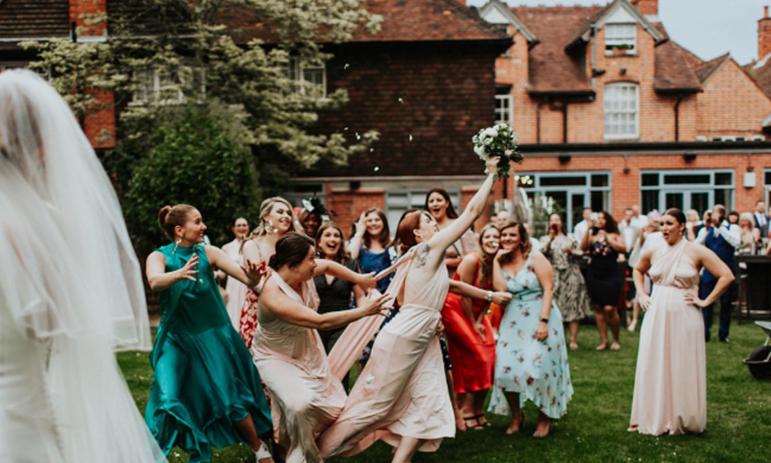 Bridesmaid catching the bouquet at The Elephant Hotel. Photo Credit: Oxana Mazur Photography