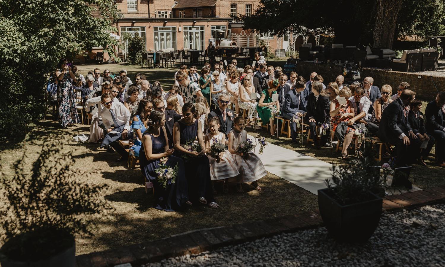 Guests at a wedding ceremony in the gardens of The Elephant Hotel