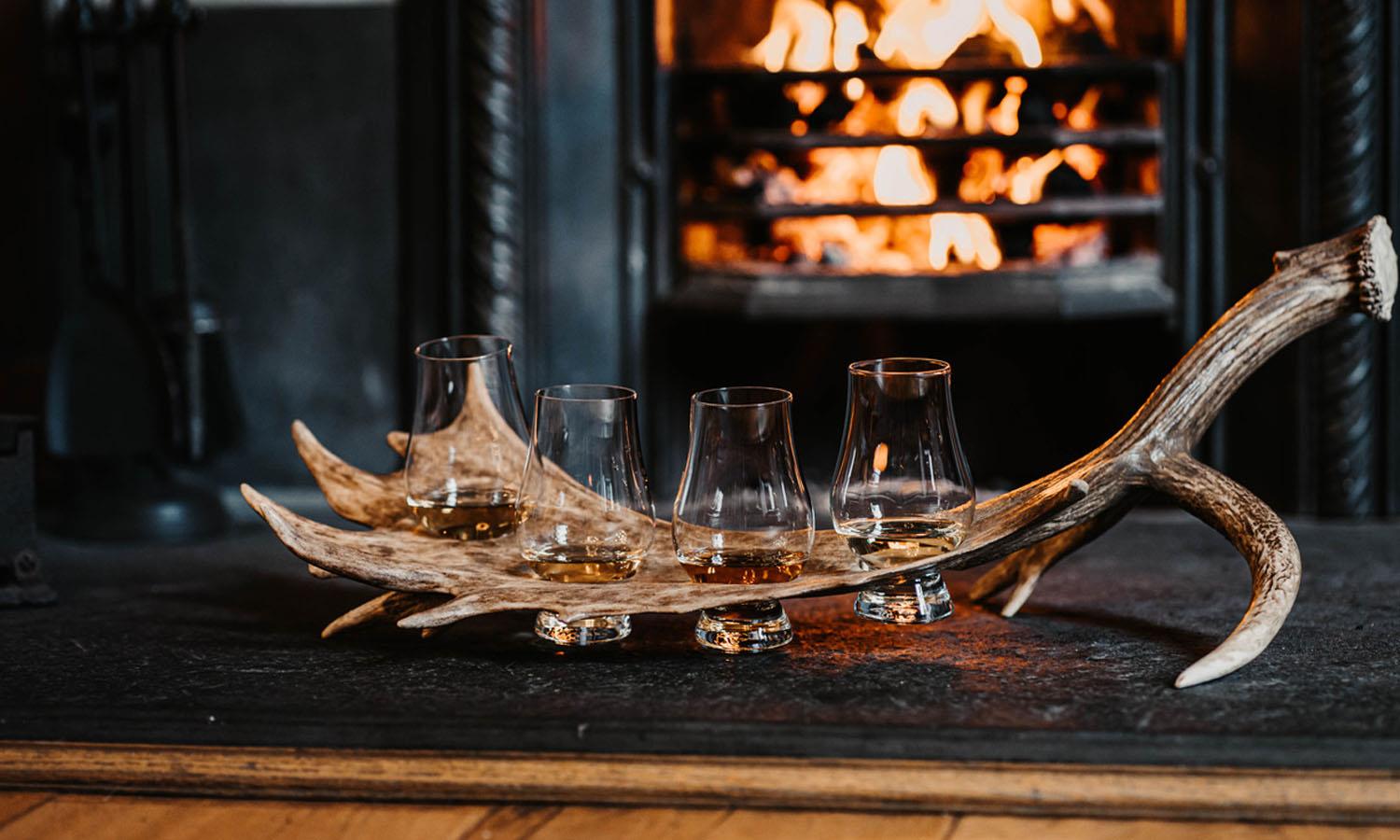 4 whisky glasses on antler